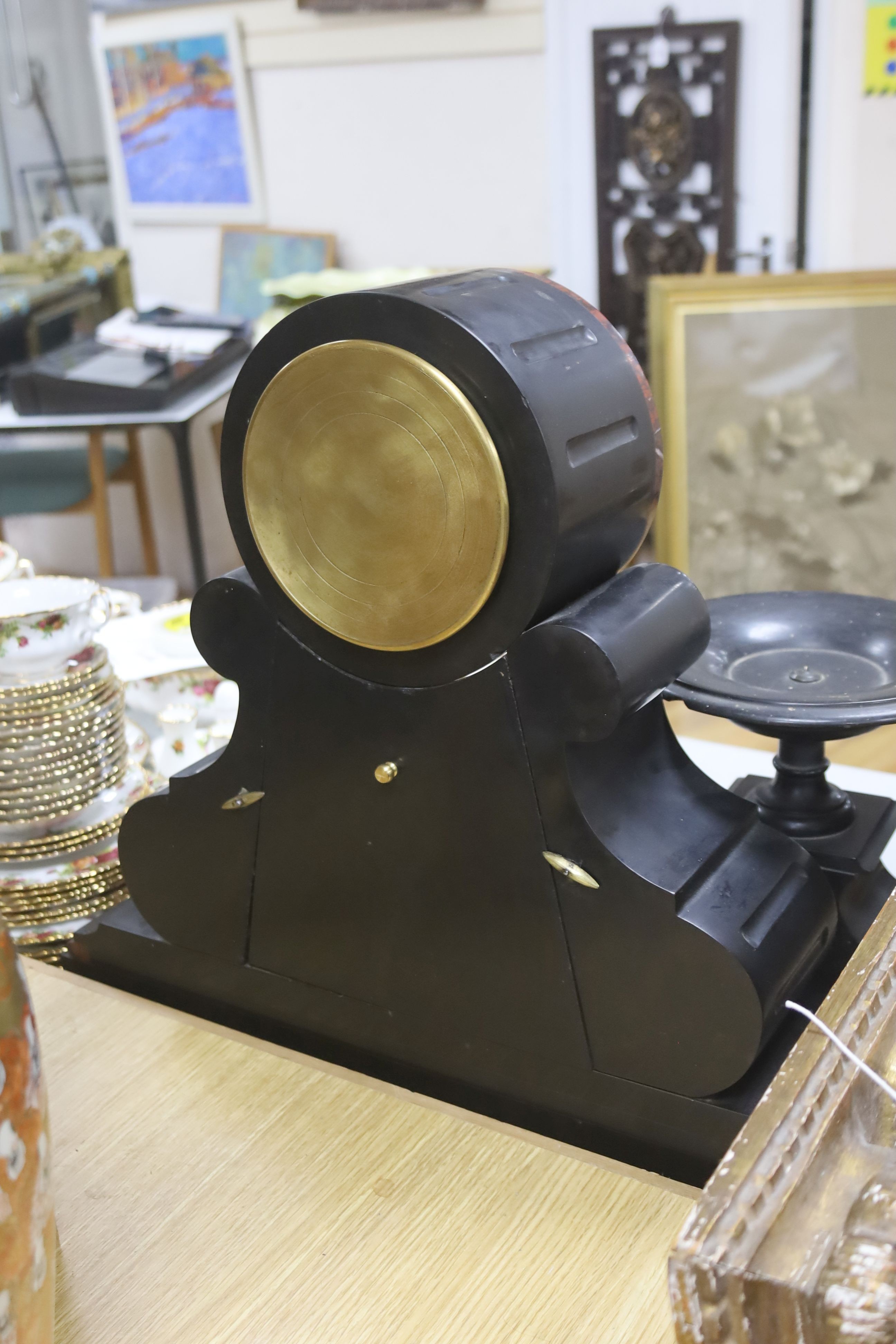 A 19th century Victorian slate clock garniture, the movement with visible Brocot escapement with key and pendulum (af), clock 49cm high